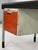 A substantial 1950s desk with double drawers and orange ABS fronts, reminiscent of the work of Marc Held, here in...