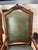 This traditional Louis XV-style carved wood armchair features rich olive green leather upholstery, tapestry upholstery...