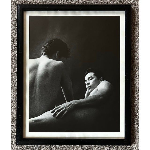 Vintage original black & white photograph of two nude men. Photograph measures 16 x 20”. In a black ebonized wood frame.