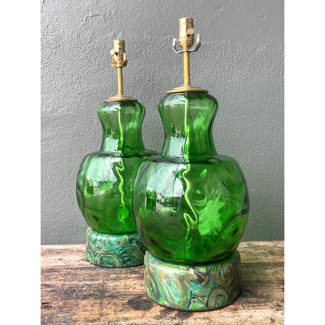 Illuminate your space with the bold sophistication of these vintage Hollywood Regency table lamps. This striking pair...