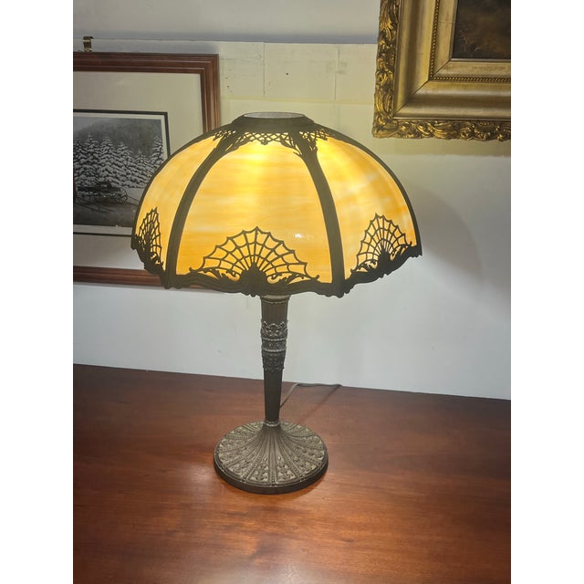 Beautiful Art Nouveau table Slag, glass lamp, and a beautiful sunset golden hue Victorian spider Web motif. This adds a...