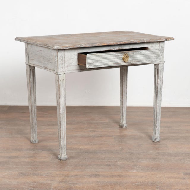 Early 19th century Swedish Gustavian side table crafted in pine with an oak drawer. The drawer features traditional...
