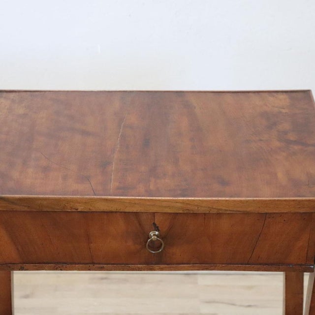 We present this refined antique Italian side table dating back to the early 19th century. It features the stylistic and...