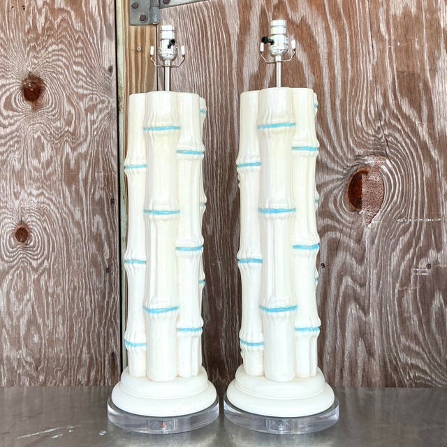 Illuminate your space with this pair of vintage coastal glazed ceramic bamboo lamps. Each lamp features a bamboo-inspired...
