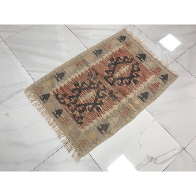 This is a vintage Turkish Anatolian kilim rug from the 1960s. The piece was hand-woven.