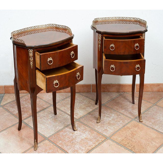 Pair of antique Napoleon III mahogany bedside tables with bronze inlays dating back to the late 19th century. The front...