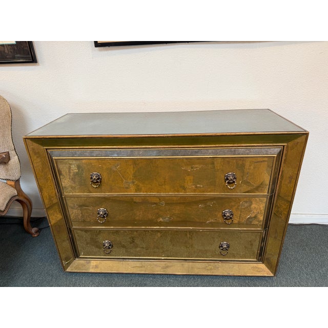 Design Plus Gallery presents a Custom Vintage Verre Eglomise Chest of Drawers. The chest has a wooden silhouette that is...