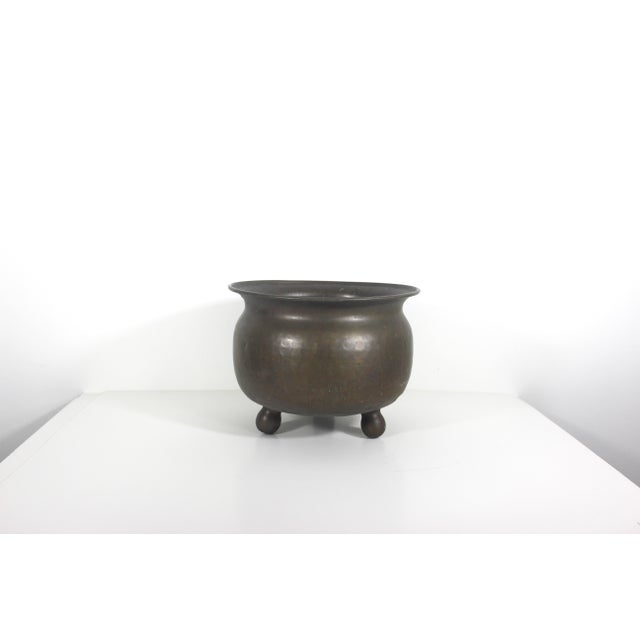 Gorgeous, large hammered brass planter with unusual ball feet. This has a wonderful rich patina with some corrosion and...