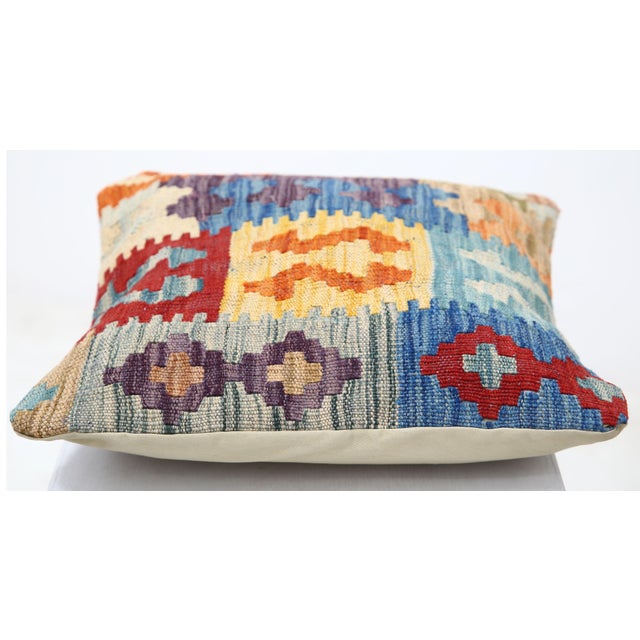 A one-of-a-kind handwoven Afghan wool kilim accent pillow featuring blocky tribal figures in cobalt, red, and orange. Cut...
