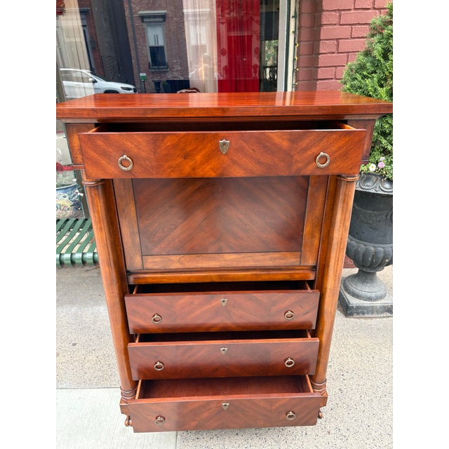 This is a French empire inspired tall writing desk. This desk has a single drawer at the top with three drawers below. The...