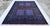 This exceptional hand-knotted wool area rug showcases a traditional Afghan Turkmen Ensi (Hachlu) pattern. The center field...
