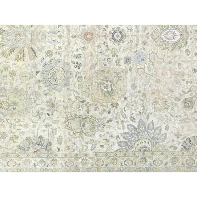 This lavish hand-knotted Persian Tabriz rug adds the perfect touch of elegance to any space. Its intricate design features...