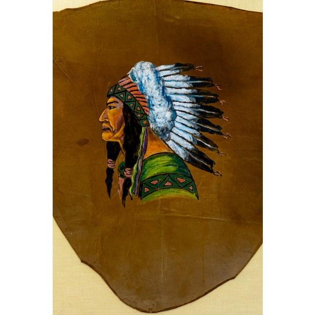 Hand-painted native American chief. Beautifully vibrant oil on tanned hide painting. Framed with complementary red framing...