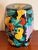 This barrel-form garden seat is decorated all over with a dense, exuberant arrangement of fruit in relief against a black...