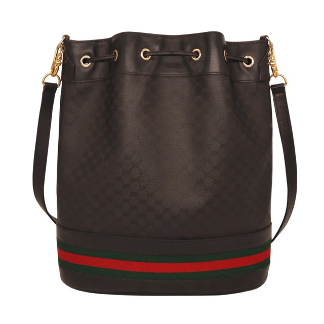 Gucci Black Leather and Canvas Micro Guccissima Drawstring Sherry Line Bag, 1980. First introduced in the early 1950s by...