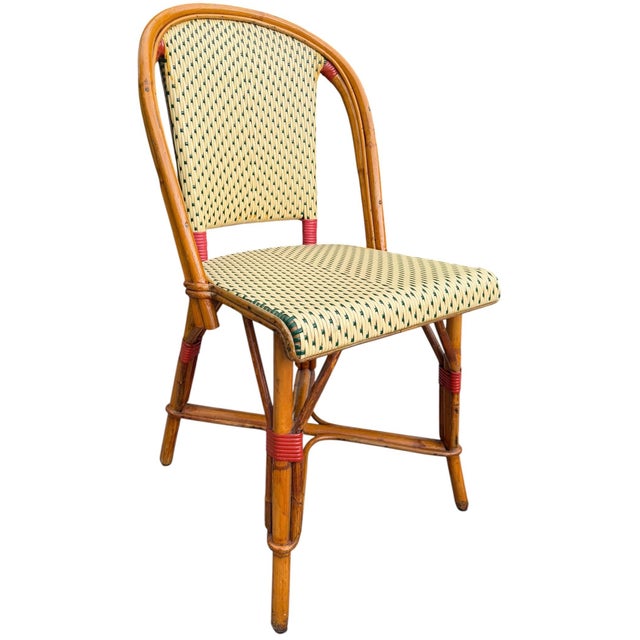 Beautiful vintage French bistro chair featuring a warm honey-toned bent bamboo frame with classic green and cream woven...