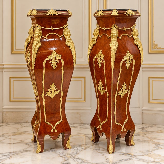Magnificent pair of French Rococo style pedestal columns crafted from fine wood and richly embellished with ornate bronze...