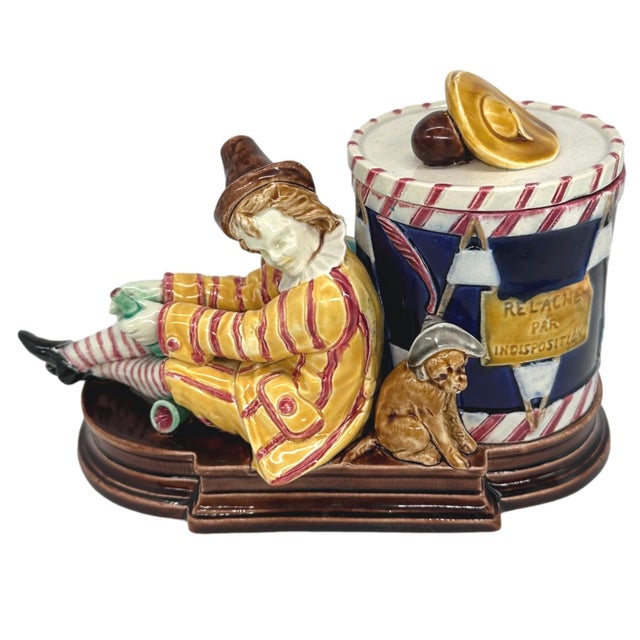 Sarreguemines Majolica Smoking Stand, molded and applied with an artiste de rue with his dog, and holding a wine bottle...