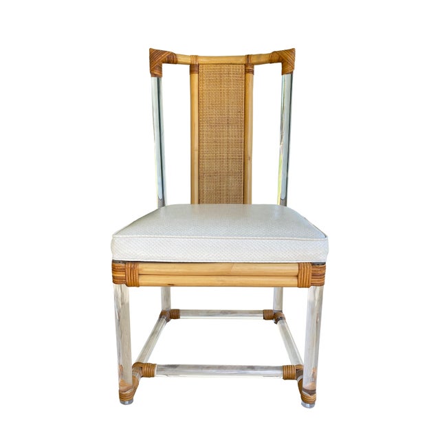A stylish set of three vintage chairs, blending rattan, bamboo, and lucite for a look that’s both natural and modern....
