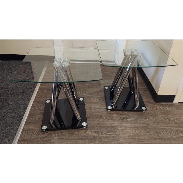 Pr. Of modern vallient design tempered glass and chrome occasional tables. The black glass at the base are in fine...
