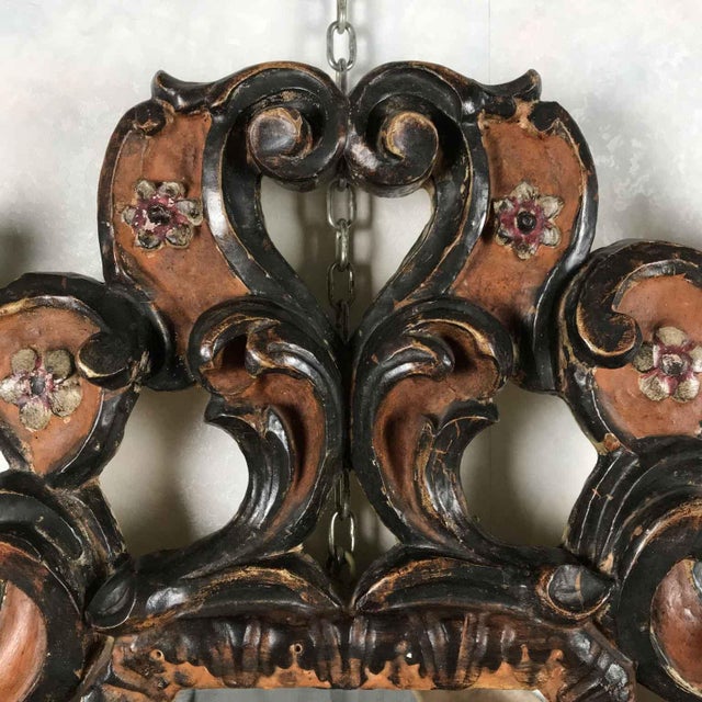 A Florentine carved, silver-plated, and red-decorated mirror from the second half of the 20th century. It features a...