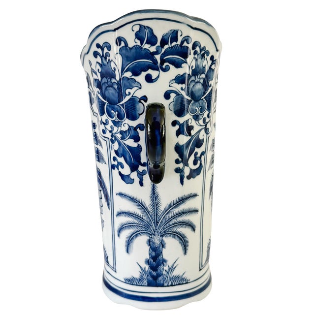 Stunning blue and white Chinoiserie porcelain vase standing 14 inches tall and featuring a classic palm tree motif and...