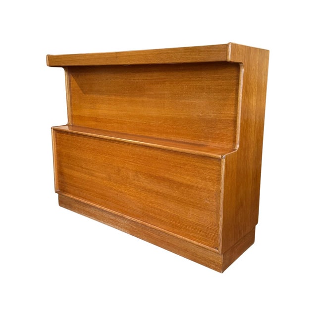 Vintage mid-century modern teak cocktail bar by Turnidge of London. Features include a lighted front, rear bottle storage...
