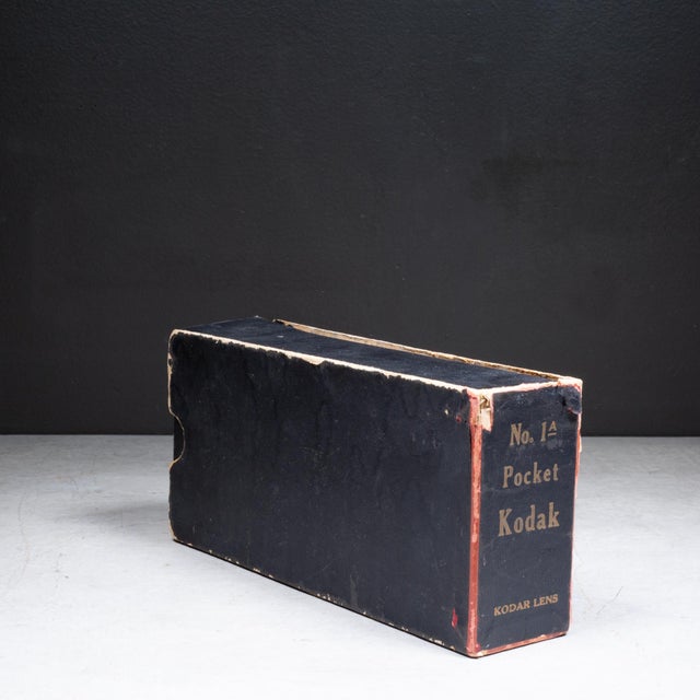 ABOUT An antique Eastman Kodak No. 1A pocket folding camera with original factory box. The body is wrapped in leather with...