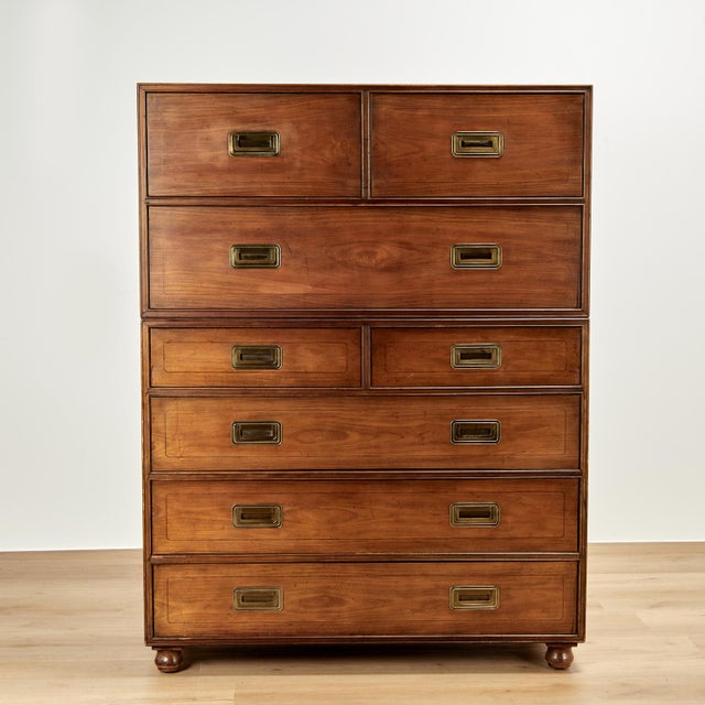 Handsome mid century campaign style chest crafted in walnut in two pieces with eight drawers, brass hardware and classic...