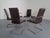 Set of 6 cantilever chairs in dark brown leather. Two of these chairs have armrests. (Width 54 cm) The leather shows...