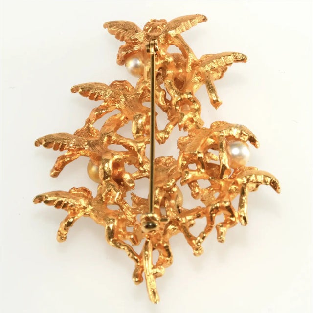 Christmas tree pin in an unusual variation with angels forming the shape of the tree. It is embellished with several...