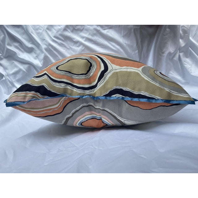 This pillow features an abstract, geode-inspired pattern in earthy tones, blues, and coral, ideal for Mid-Century Modern,...