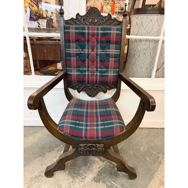 Striking antique Savonarola-style armchair with a curving X-form frame, carved foliate details, tall finial-topped back,...