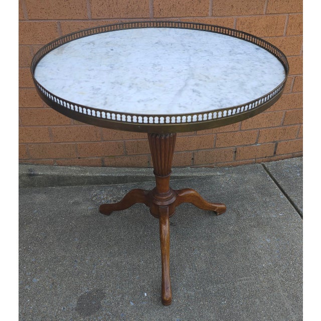 A Mid-Century French Mahogany and Marble Top Galleried Tripod Pedestal Gueridon Table. Metal brass gallery and Carrera...