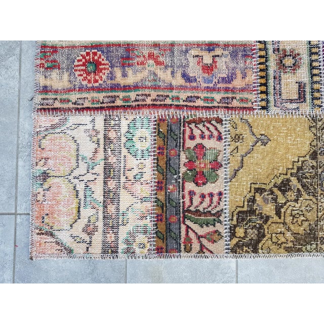 This is a vintage Turkish Oushak rug from the Mid 20th Century. The piece was hand-knotted.