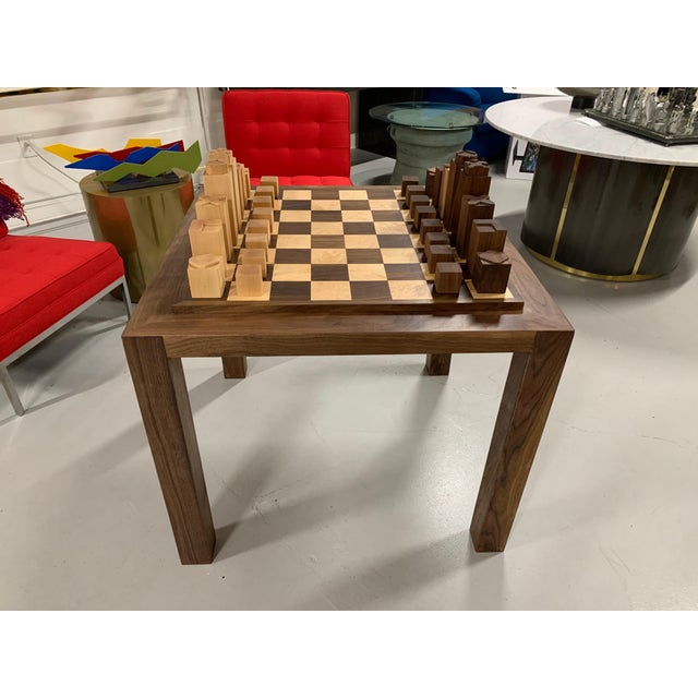 A custom made walnut and maple chess set and game table we commissioned. It is solidly made with squares of curly maple...