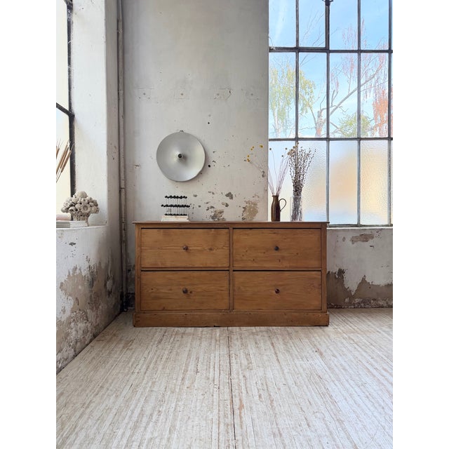 A 1950s pine workshop cabinet with large drawers. we love its clean lines and the four wide drawers topped with wooden...