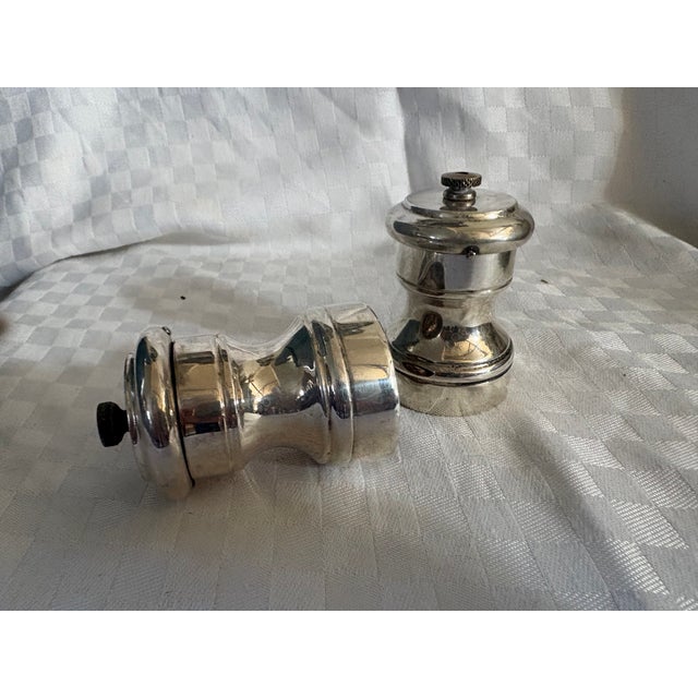 Two petite sterling silver grinders. One is for salt and the other is for pepper. Both grinders function well and make a...