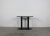 Console table with a base in black lacquered metal and an ovoidal table top in granite, originally designed by Aimaro...