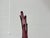 An elegant, mouth-blown Murano glass vase from the 1950s, featuring a sculpturally curved silhouette and a deep violet...