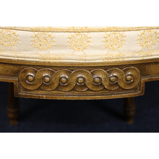 A handsome and classically proportioned pair of French Louis XVI-style carved walnut armchairs, distinguished by their...