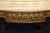 A handsome and classically proportioned pair of French Louis XVI-style carved walnut armchairs, distinguished by their...