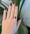 A 4.3-carat red madagascar ruby pear sits at the centre of this solid 14K white gold ring, framed by thirty-seven earth-...