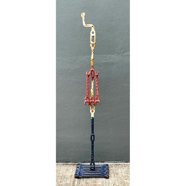 Crafted from welded metal wrenches, this vintage industrial sculpture stands at an impressive height of 62.25 inches. The...