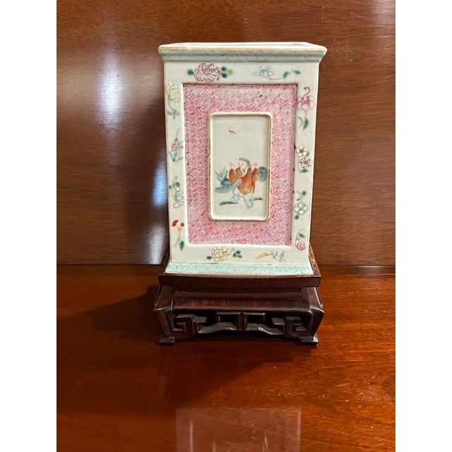 Gorgeous vase on a wood base from the late 19th century or early 20th century. The alternating sides have pink or blue...