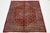 This Persian Mahal hand-knotted wool rug features a vibrant red field, beautifully complemented by multicolored accents...