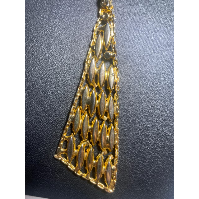Alice Caviness Modernist statement necklace features a bold 4-inch asymmetrical "sail" pendant crafted in a high-end, cast...