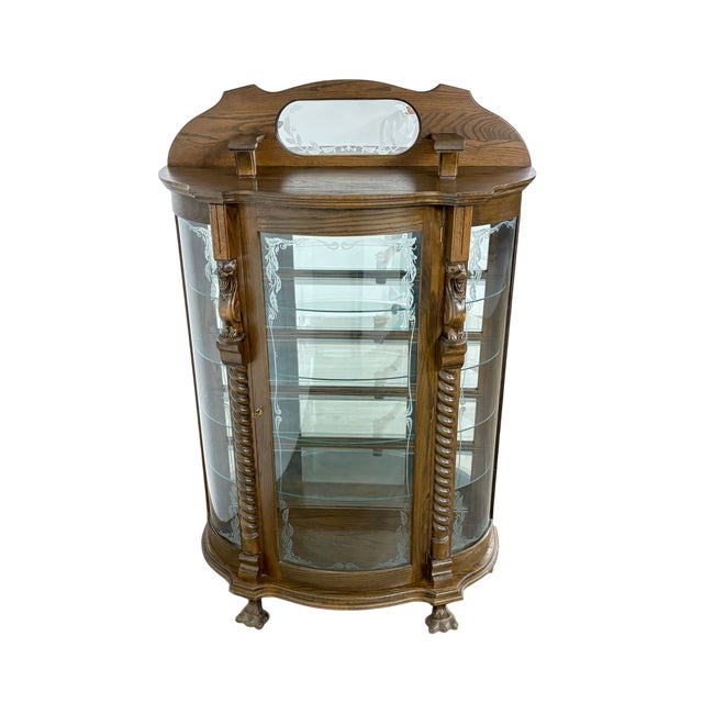 This finely preserved family heirloom display cabinet exemplifies traditional craftsmanship and Old World design....