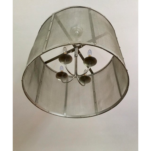 Great ceiling fixture for many different styles of interiors. Metal frame composed of eight metal ribs with mesh caging...