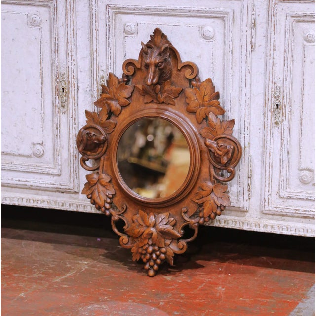 Decorate a wall or entry with this richly carved antique Black Forest wall mirror. Crafted in France circa 1880, the oval...